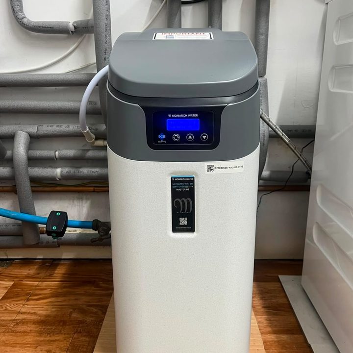 Monarch water softener installed in a utility cupboard